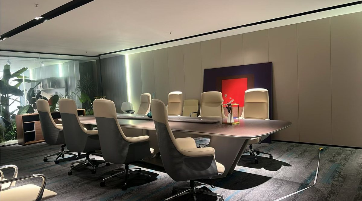 Conference table program with matching executive chairs in a showroom meeting room setup
