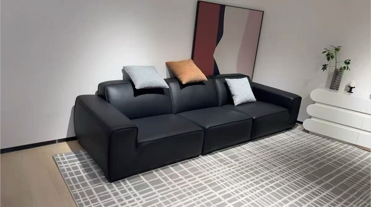 Black leather three-seat sofa on display in a Foshan showroom