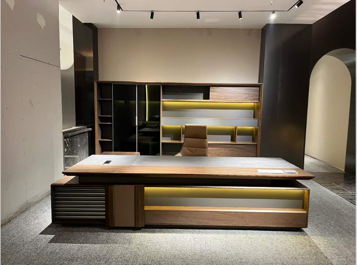 Walnut veneer executive desk with lighted background storage cabinet in showroom setting